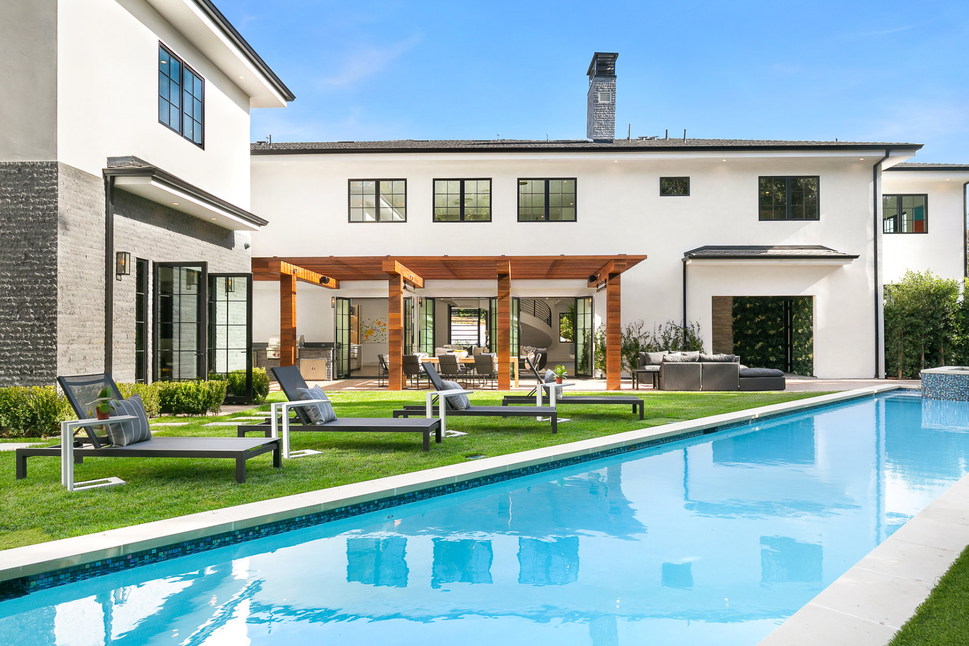 Modern white home with lap pool and pergola