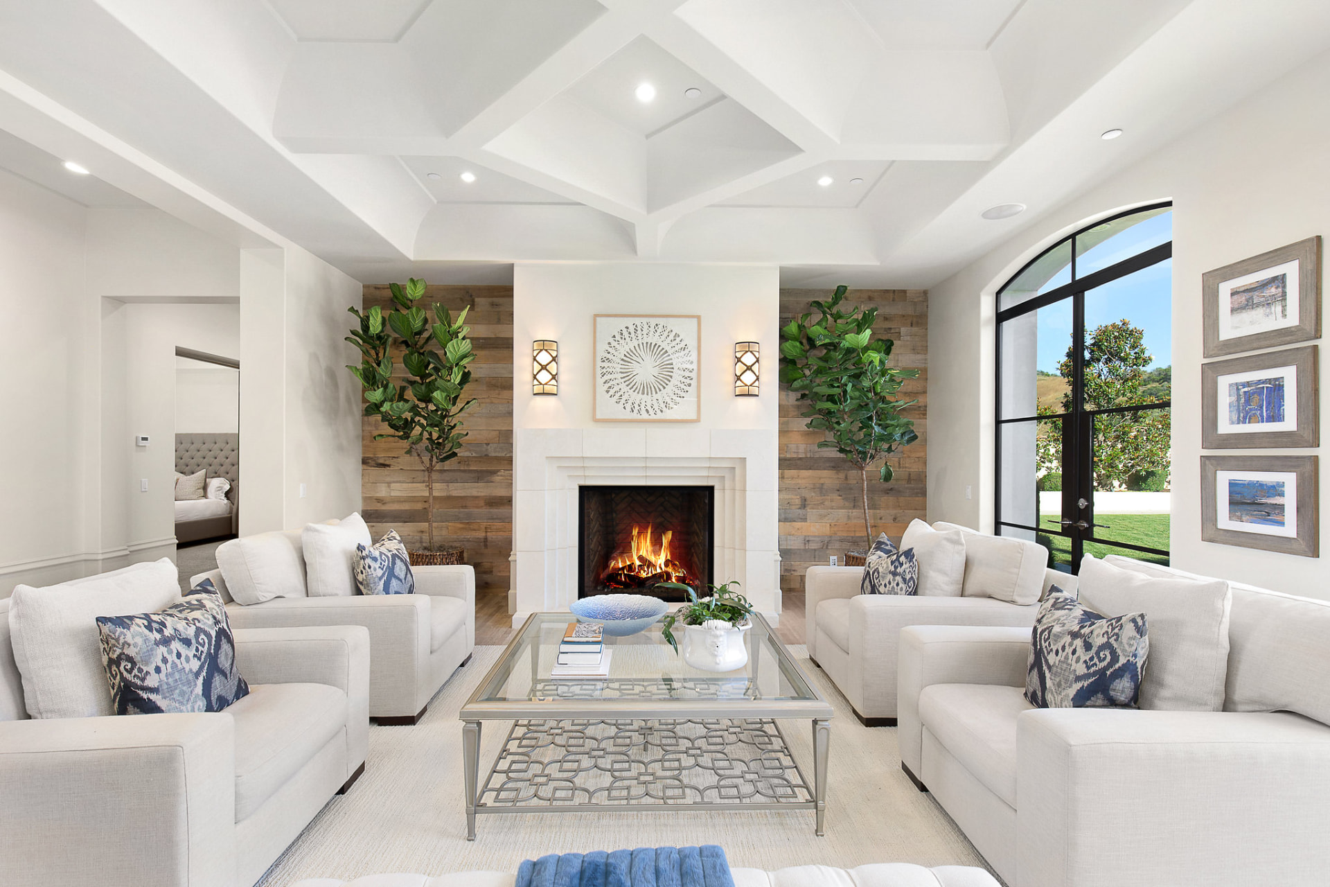Bright white living room with vaulted ceiling and fireplace