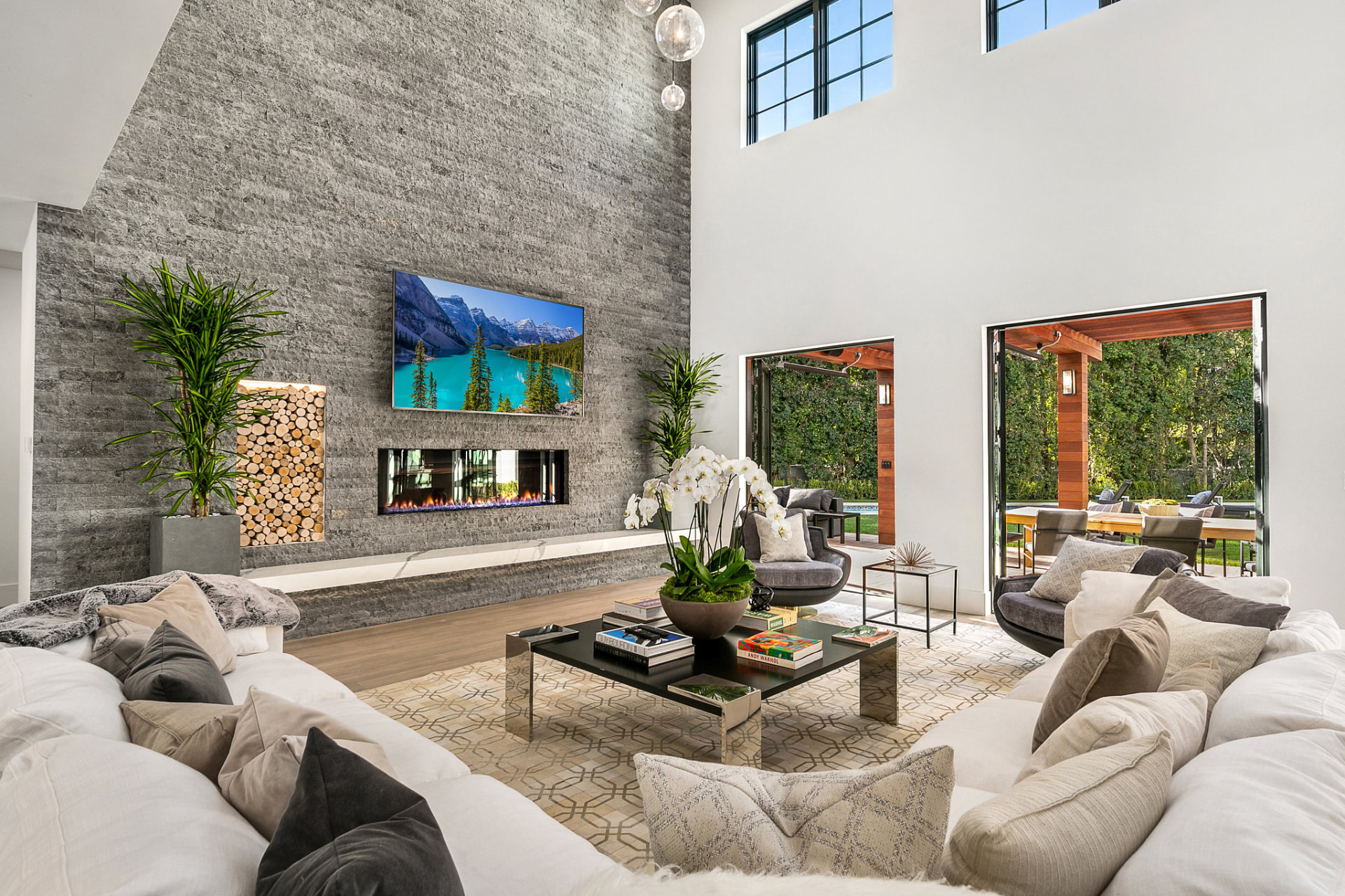 Living room with floor-to-ceiling stone fireplace wall