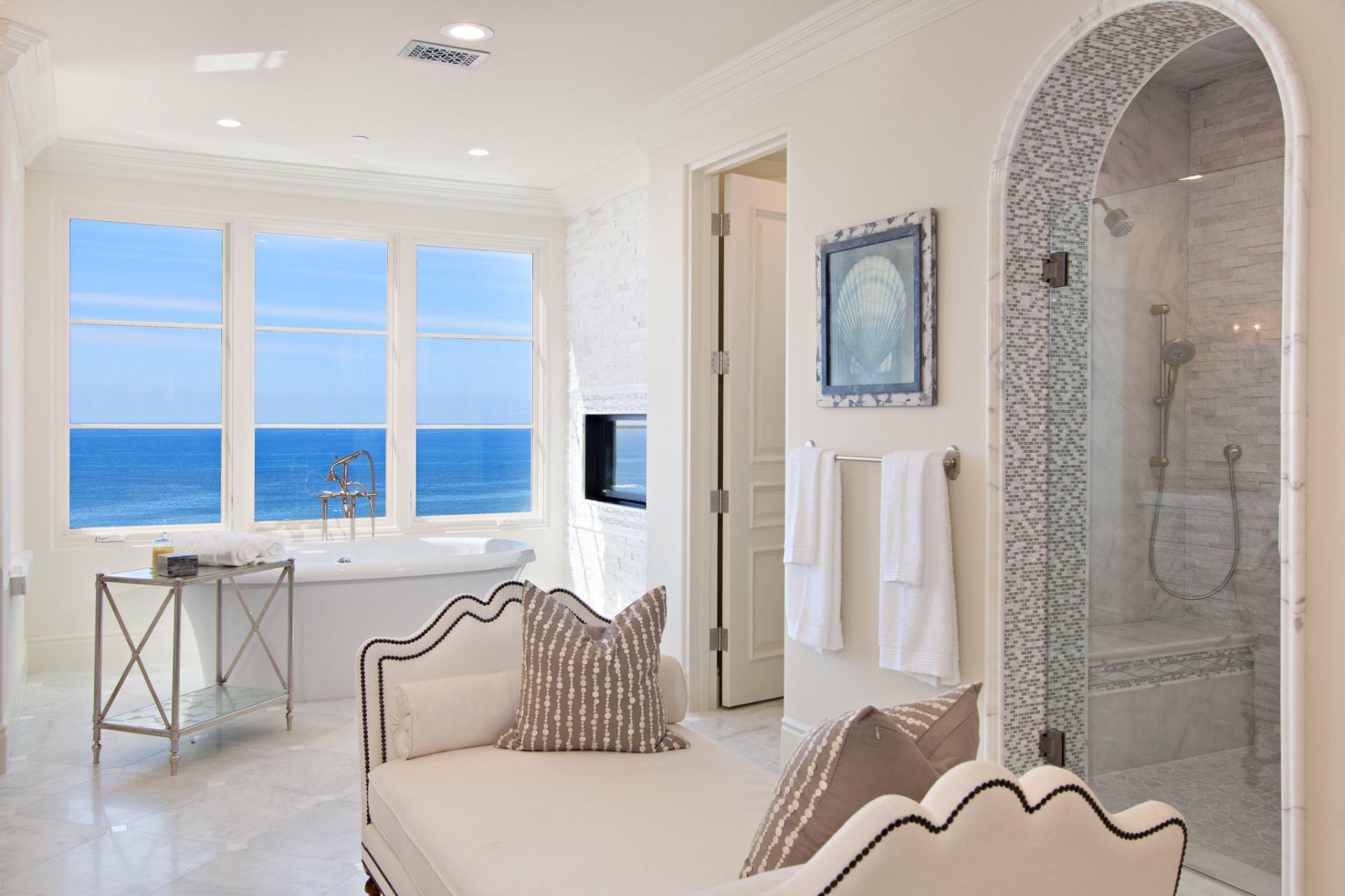 Ocean-view bath suite with arched tiled shower
