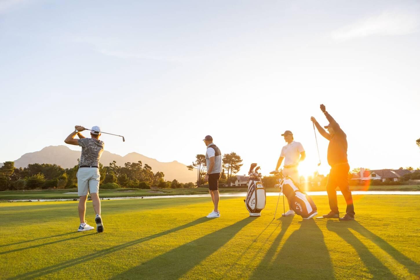 A foursome enjoying a beautiful golf course at golden hour